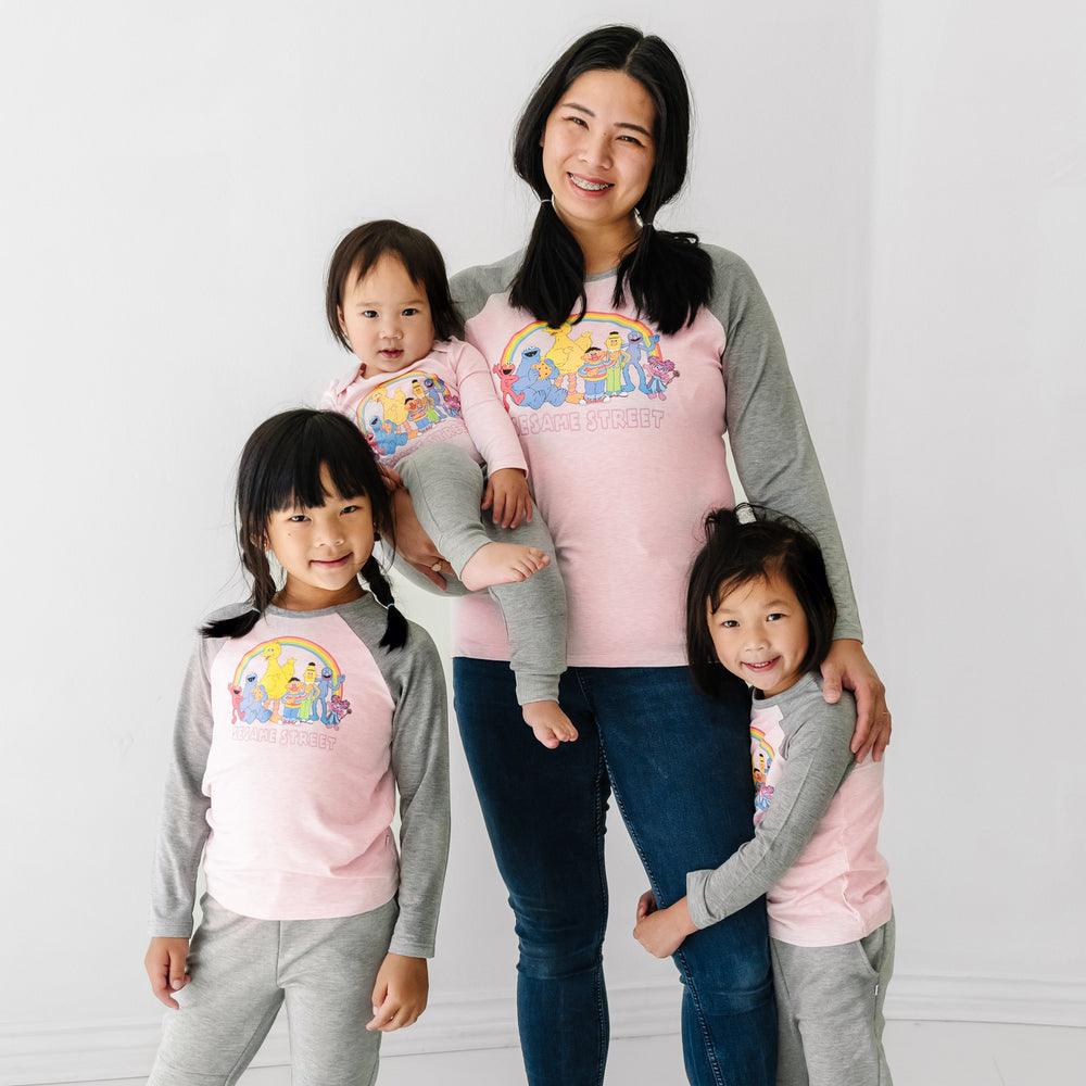 Family of four wearing matching Sesame Street raglan tees