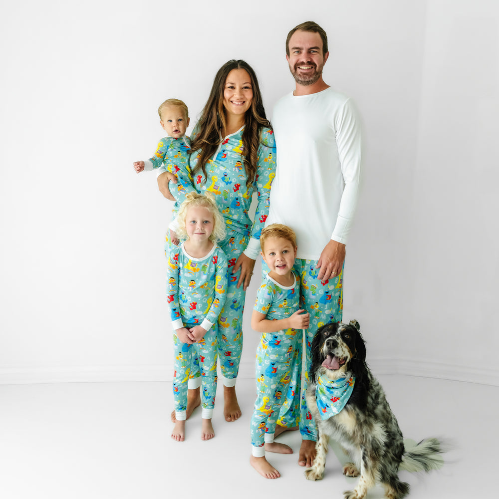 Family and dog wearing matching Spelling with Sesame Street pet bandana and pajamas