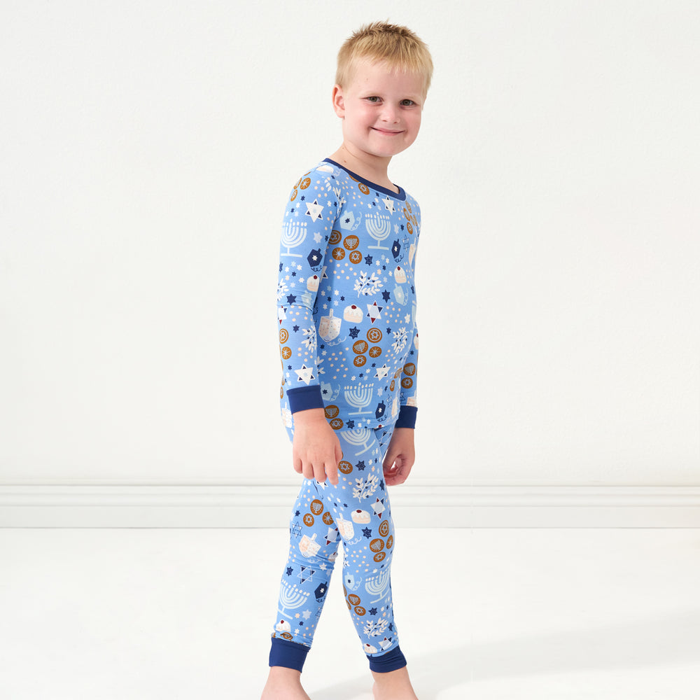 Profile view of a child wearing Hanukkah Lights and Love two piece pajama set