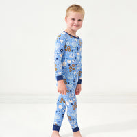 Profile view of a child wearing Hanukkah Lights and Love two piece pajama set
