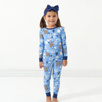 Child wearing Hanukkah Lights and Love two piece pajama set paired with a Sapphire luxe bow headband