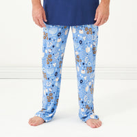 Alternate image of close up image of a man posing wearing a Hanukkah Lights and Love men's pajama pants paired with a men's Sapphire short sleeve pajama top