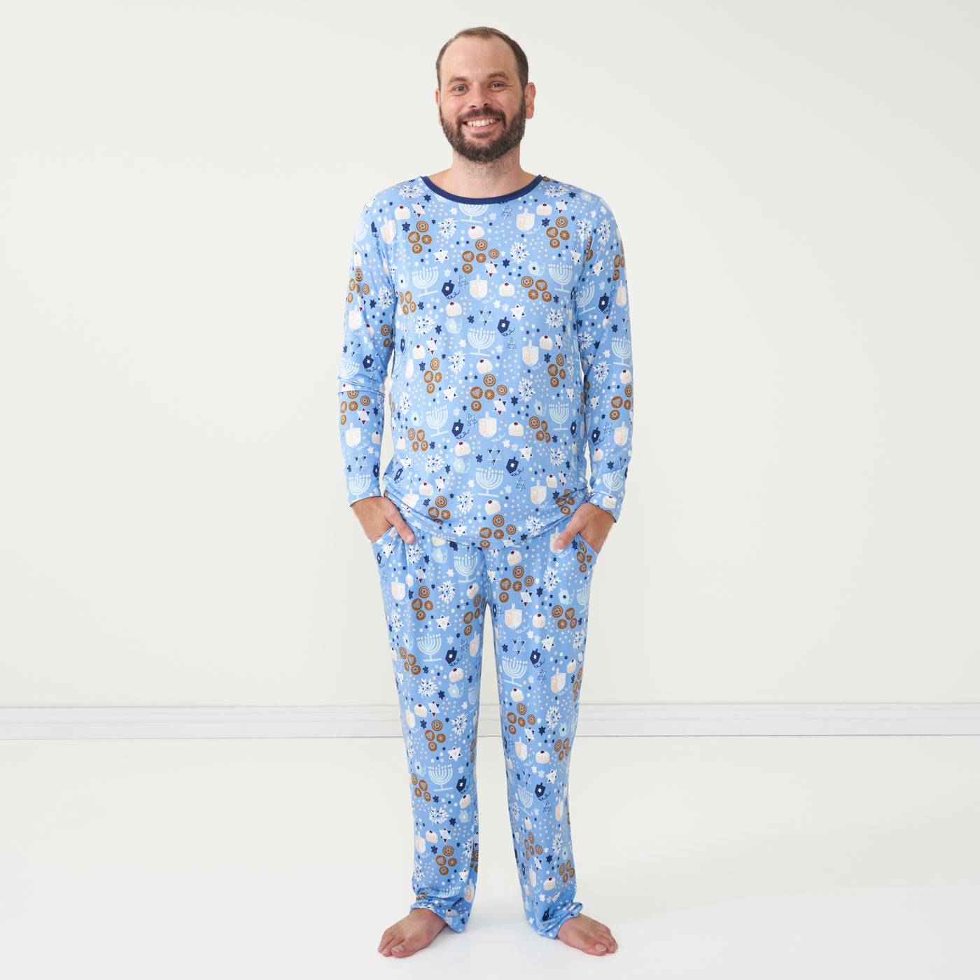 man wearing a men's Hanukkah Lights and Love pajama top paired with men's Hanukkah Lights and Love pajama pants