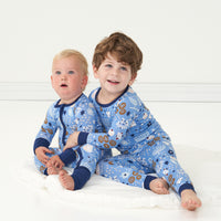 two children together wearing Hanukkah Lights and Love pajamas in zippy and two piece styles