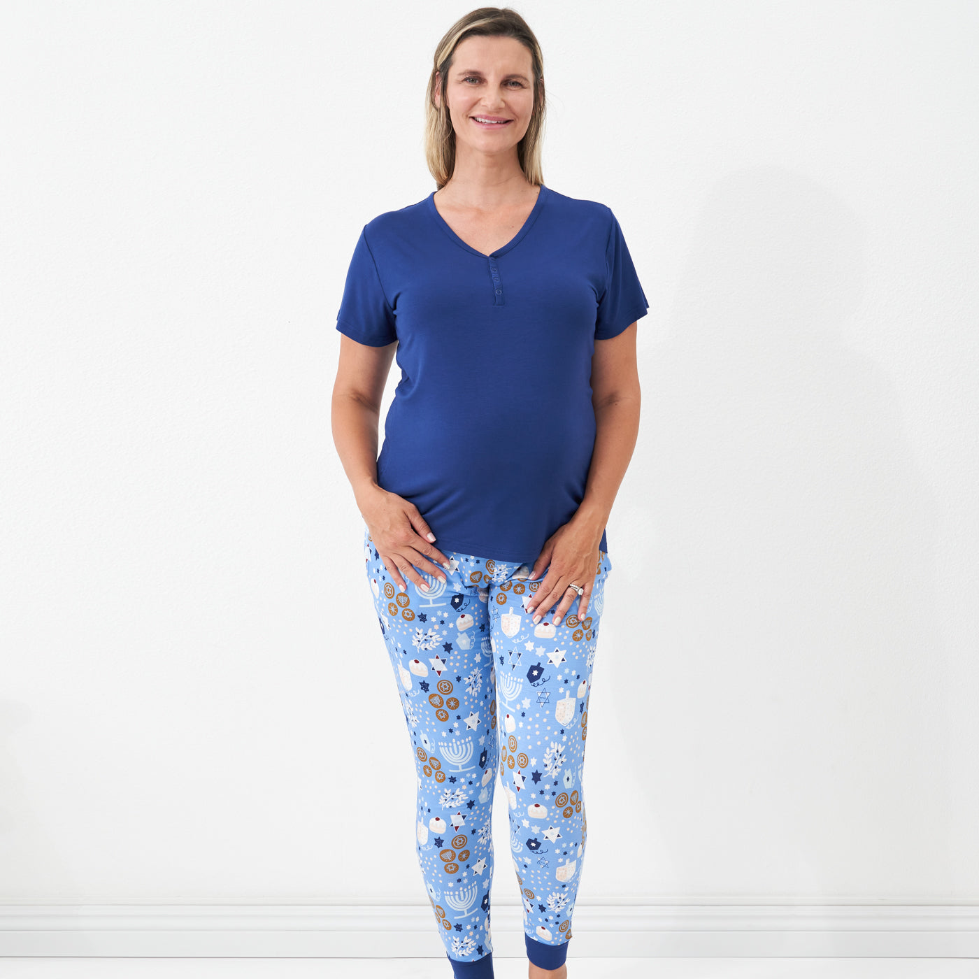 Woman wearing Hanukkah Lights and Love women's pajama bottoms paired with a women's Sapphire short sleeve pajama top