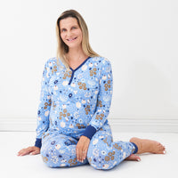 woman sitting wearing Hanukkah Lights and Love women's pajama top paired with matching women's pajama bottoms
