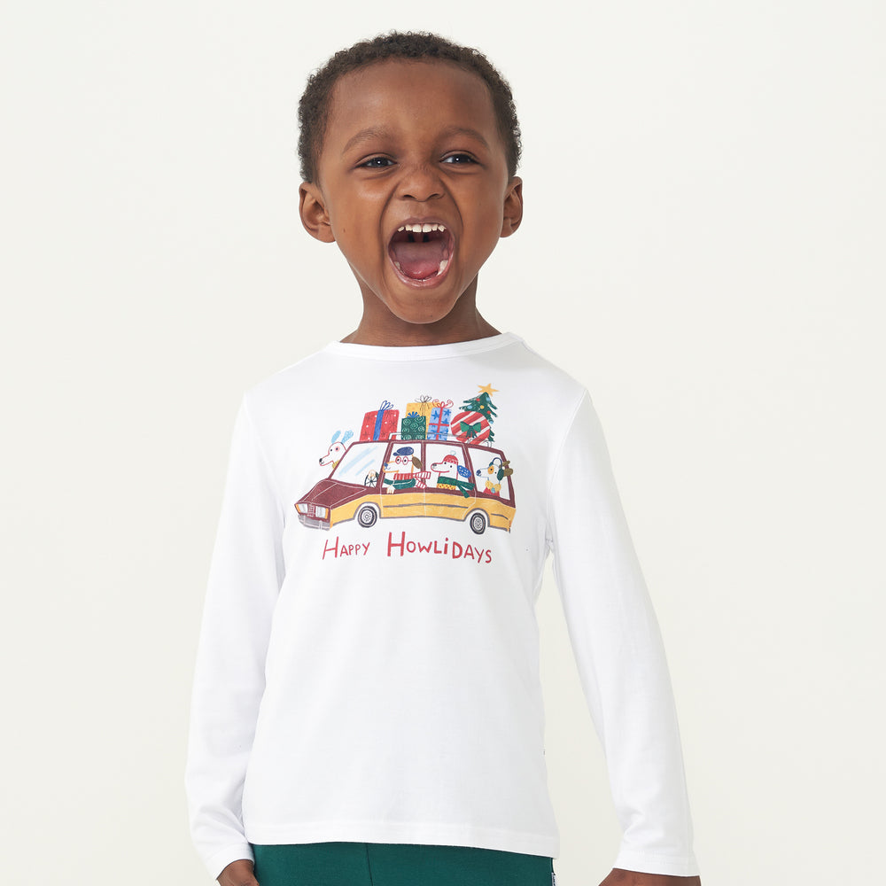 Child laughing wearing a Happy Howlidays graphic tee