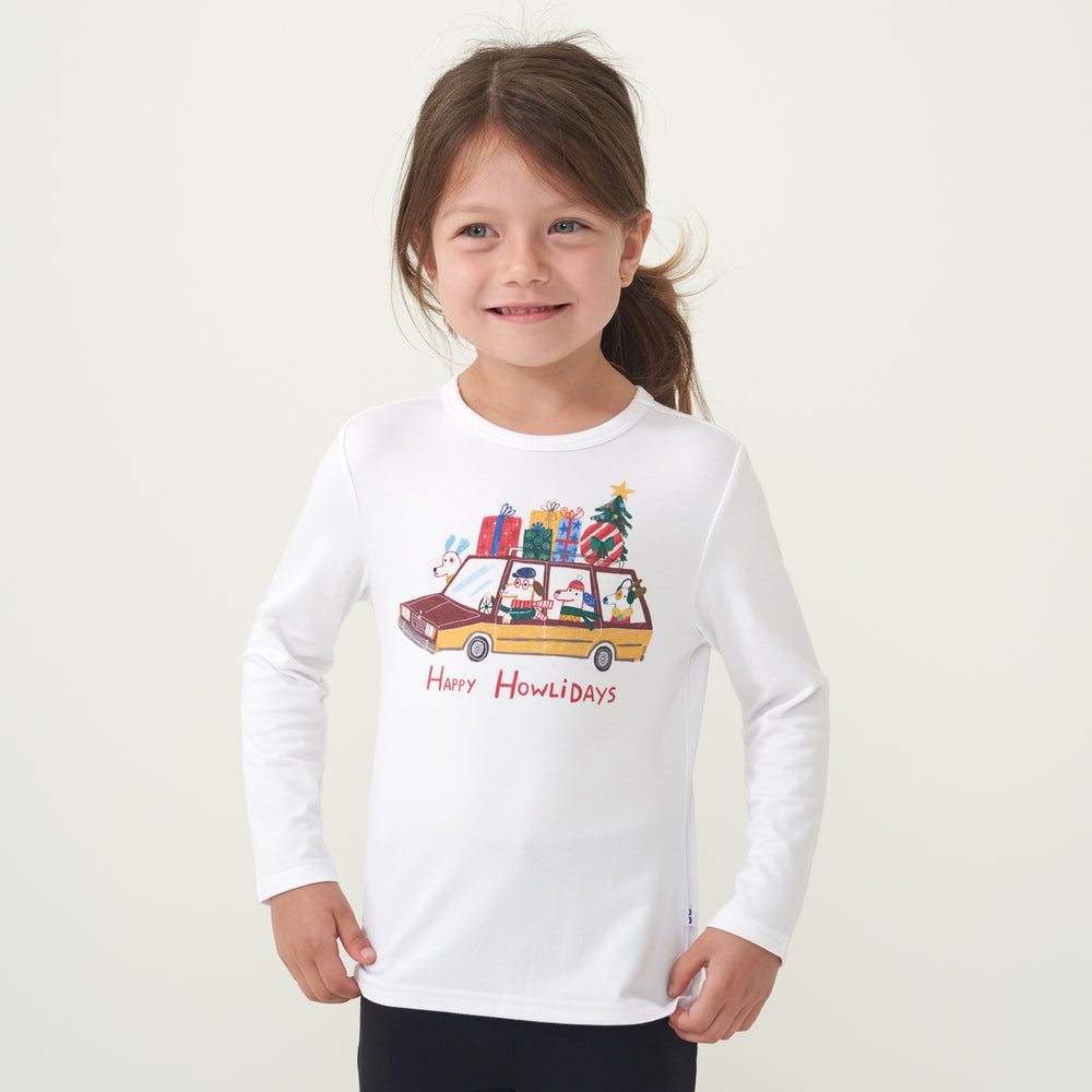 Child with her hands on her hips wearing a Happy Howlidays graphic tee