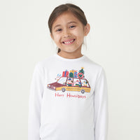 Close up image of a child wearing a Happy Howlidays graphic tee