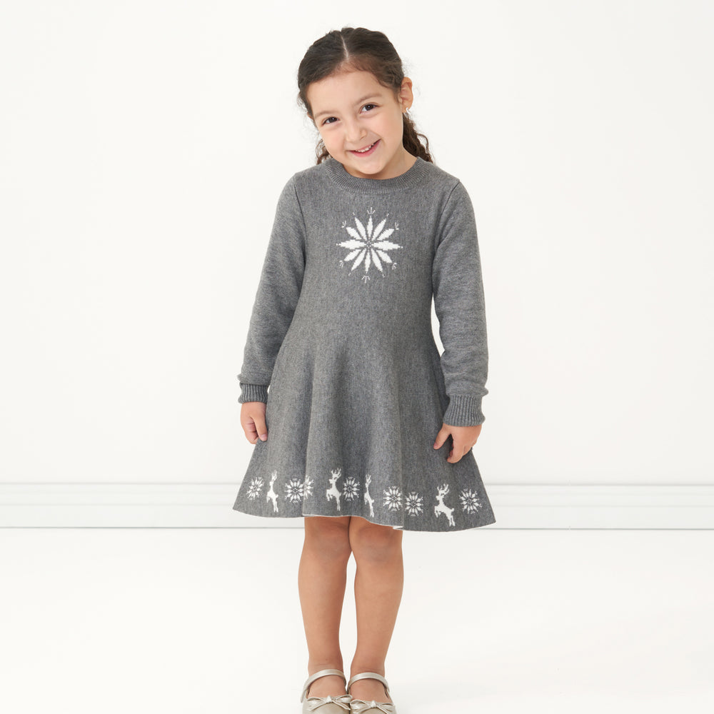 Child wearing a Heather Charcoal Snowflake Sweater Dress