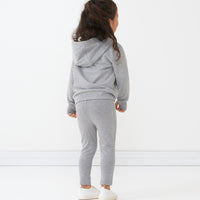 Back view of a child wearing Heather Gray cozy leggings and matching hoodie