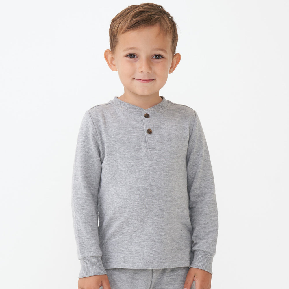Child wearing a Heather Gray henley tee