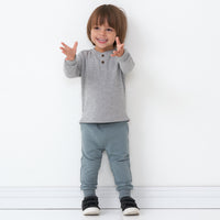 Child wearing a Heather Gray henley tee paired with coordinating joggers