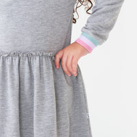 Close up image of the Heather Gray drop waist dress detailing the waist line and sleeve cuff
