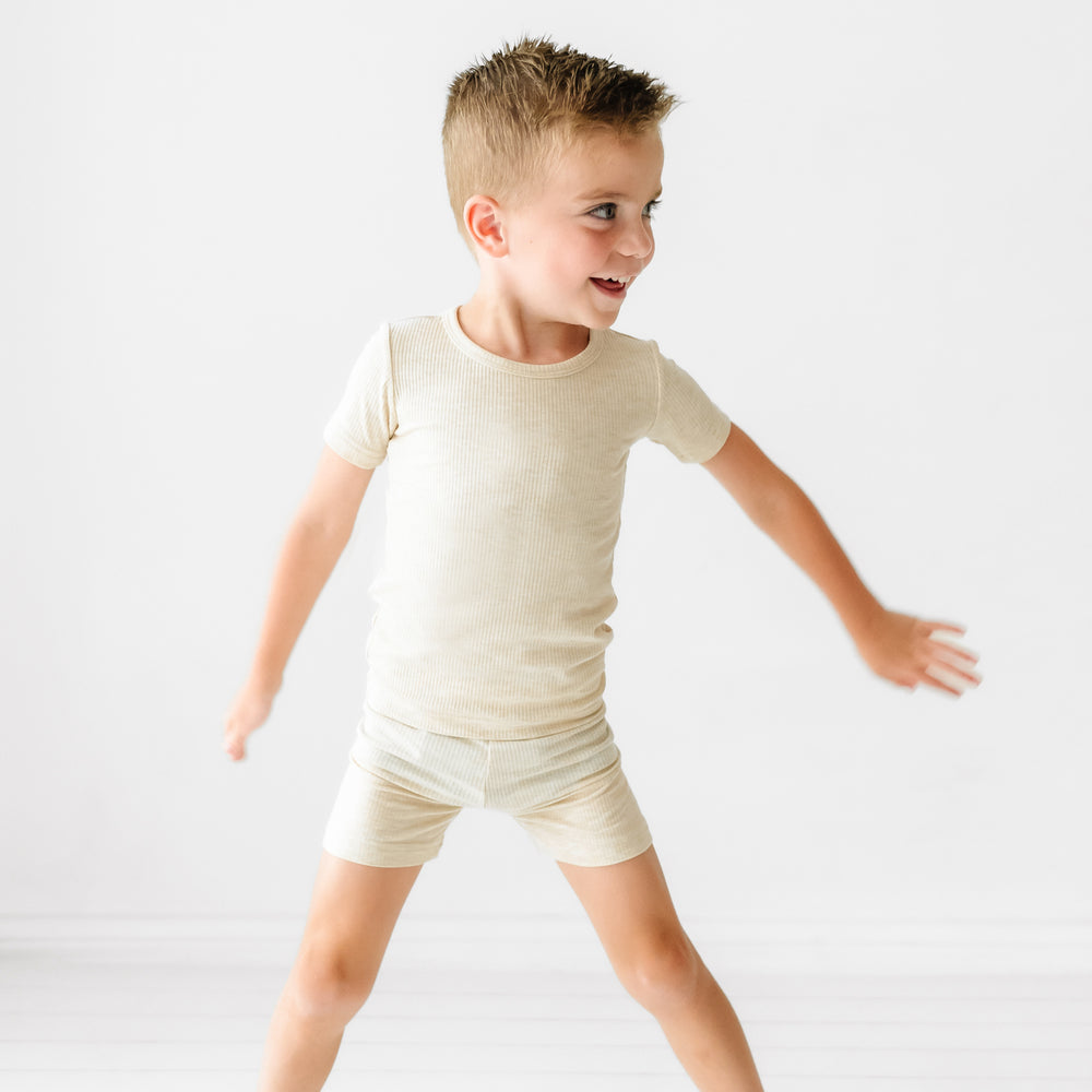 Child wearing Heather Oatmeal Ribbed two piece short sleeve and shorts pajama set