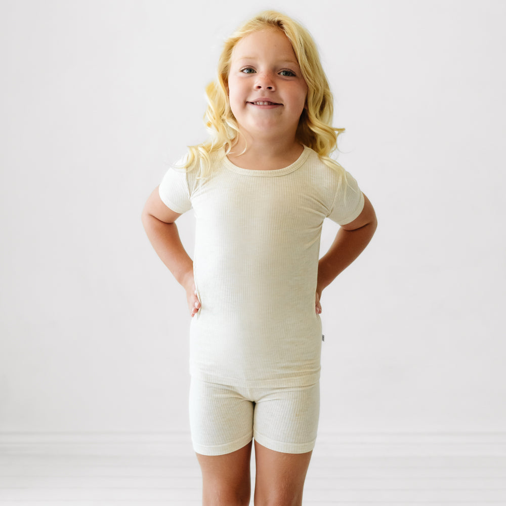 Alternate image of a child posing wearing Heather Oatmeal Ribbed two piece short sleeve and shorts pajama set