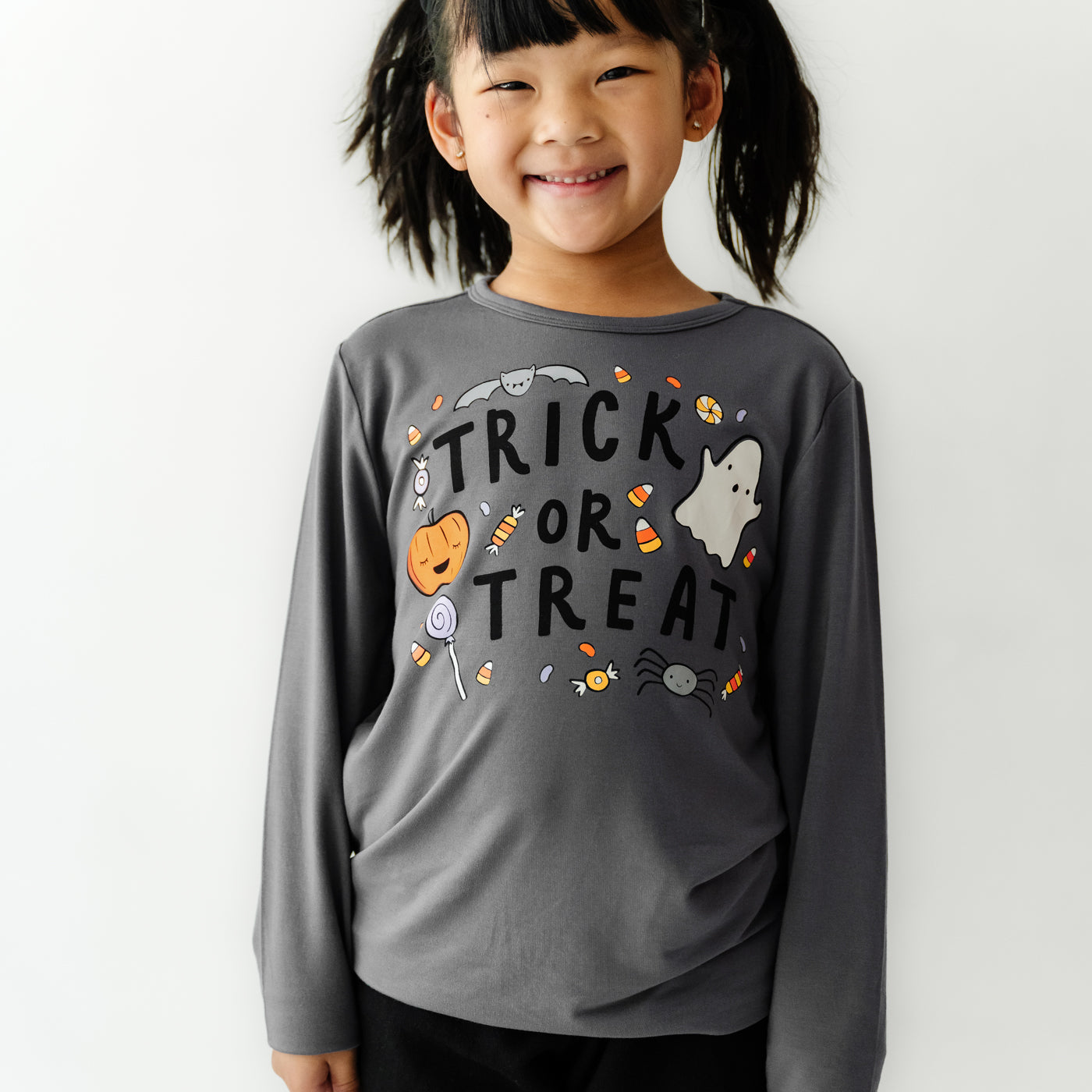 Child wearing a Trick or Treat graphic tee paired with Black Leggings
