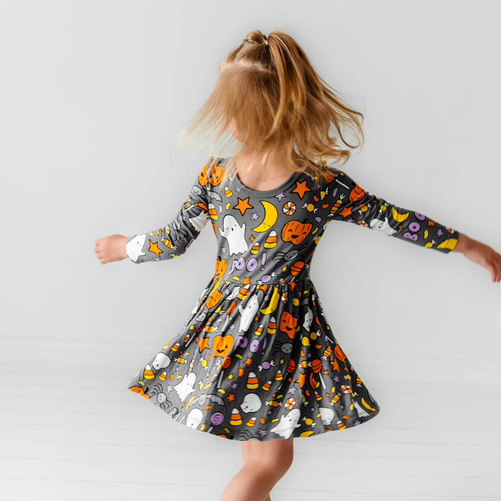 Child twirling wearing a Hey Boo printed twirl dress with bodysuit