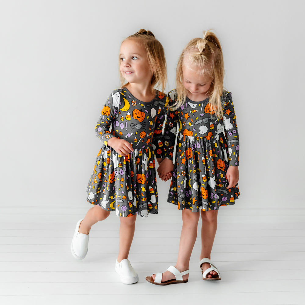 Alternate image of two children holding hands wearing Hey Boo printed twirl dresses with bodysuits