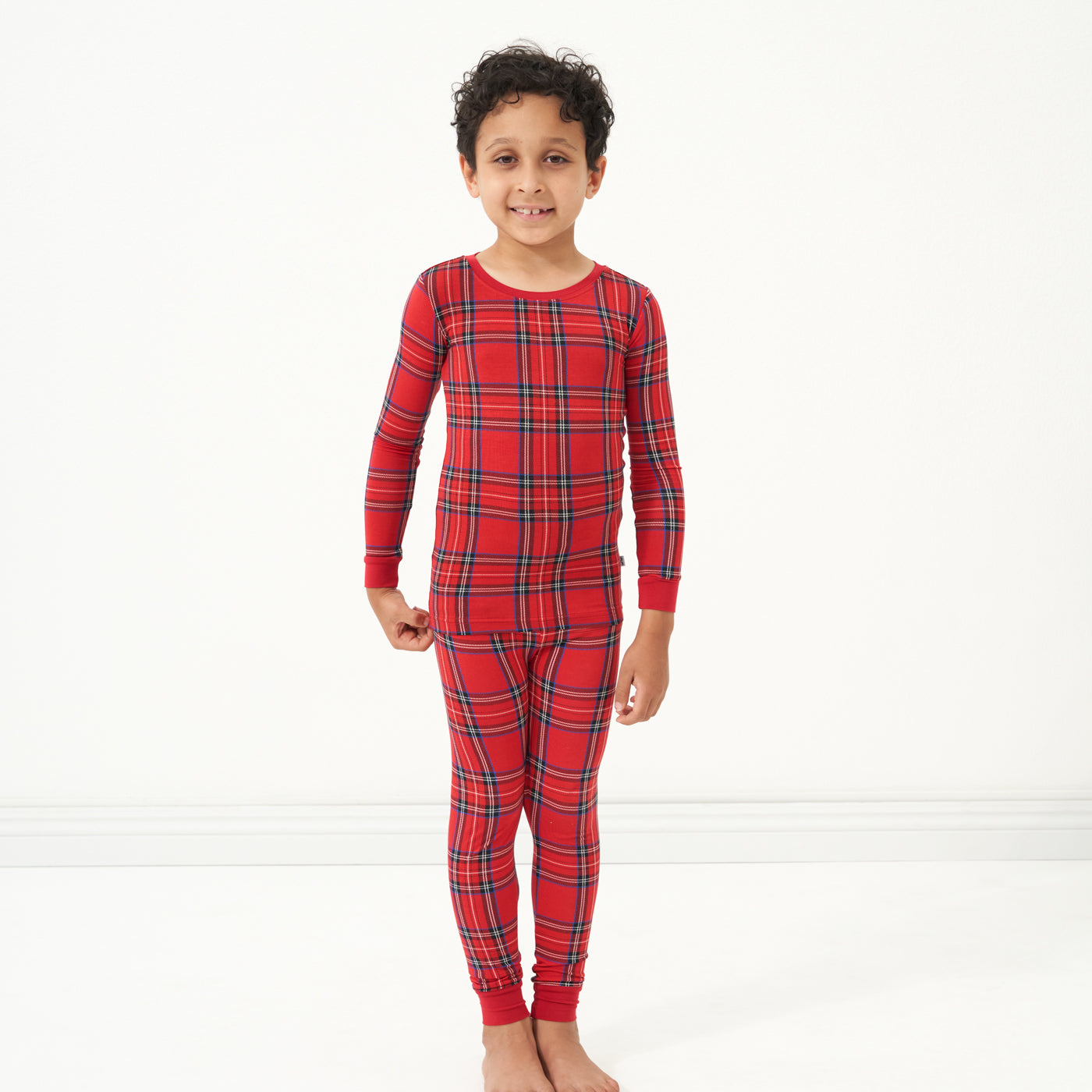 Child wearing a Holiday Plaid two piece pajama set