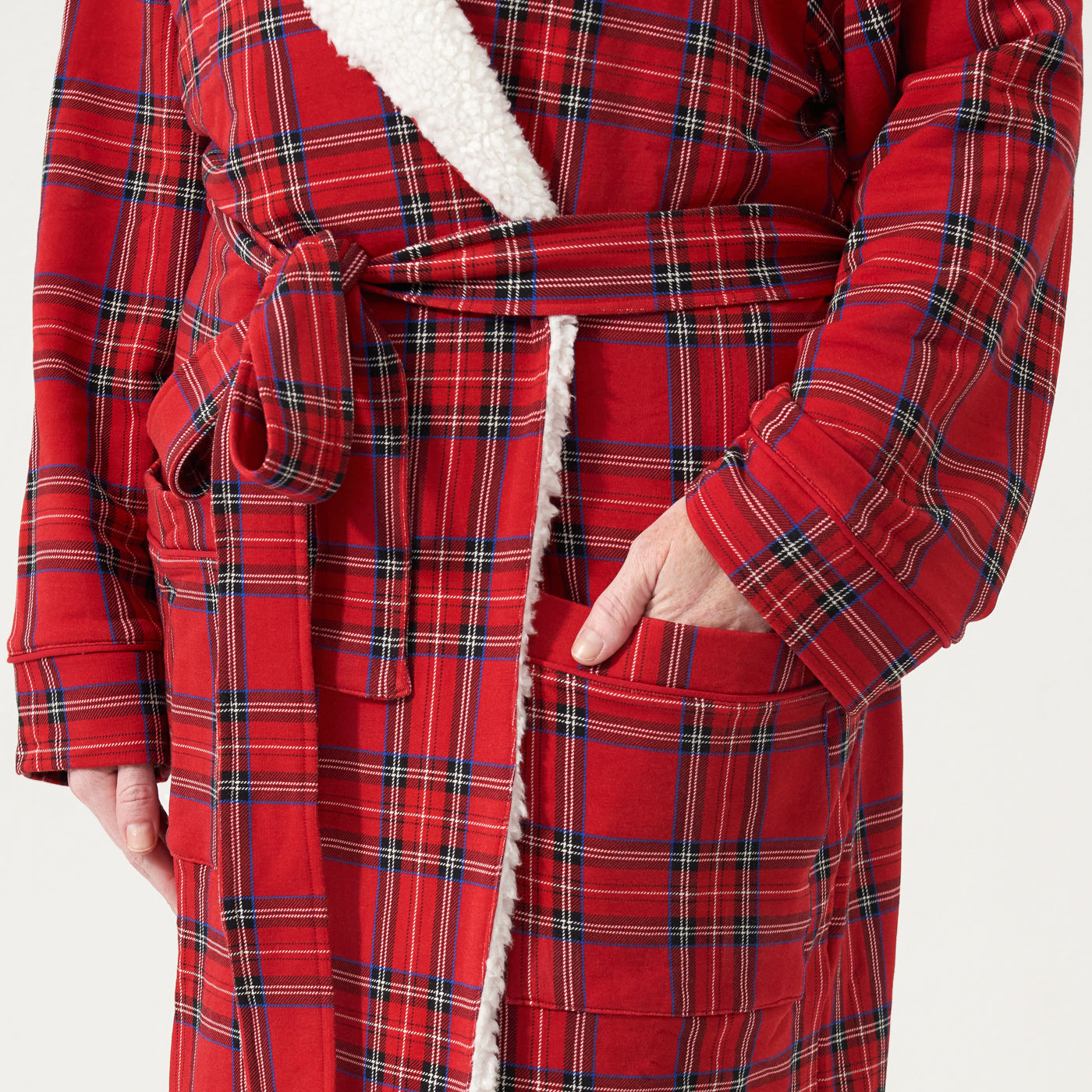 Close up image of a man wearing a Holiday Plaid cozy robe detailing the pocket
