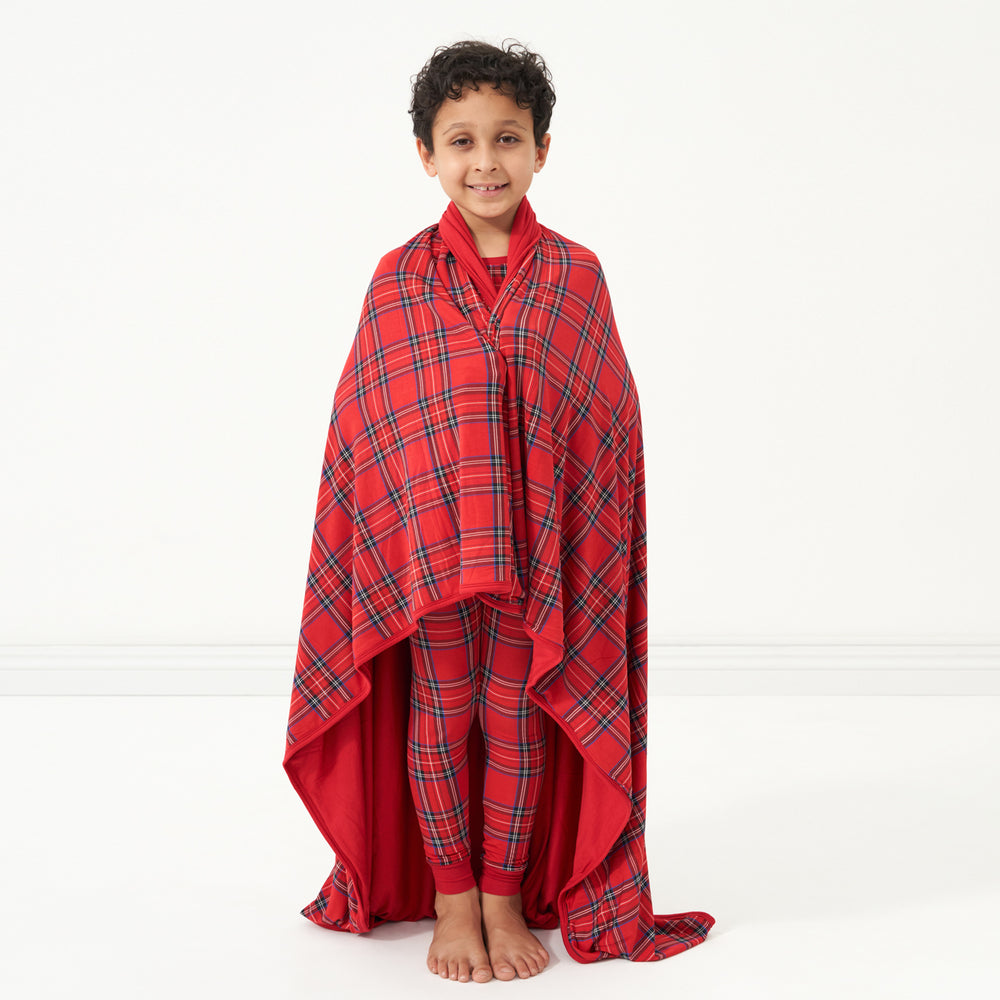 Child with a Holiday Plaid large cloud blanket wrapped around them