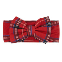 Flat lay image of a Holiday Plaid luxe bow headband