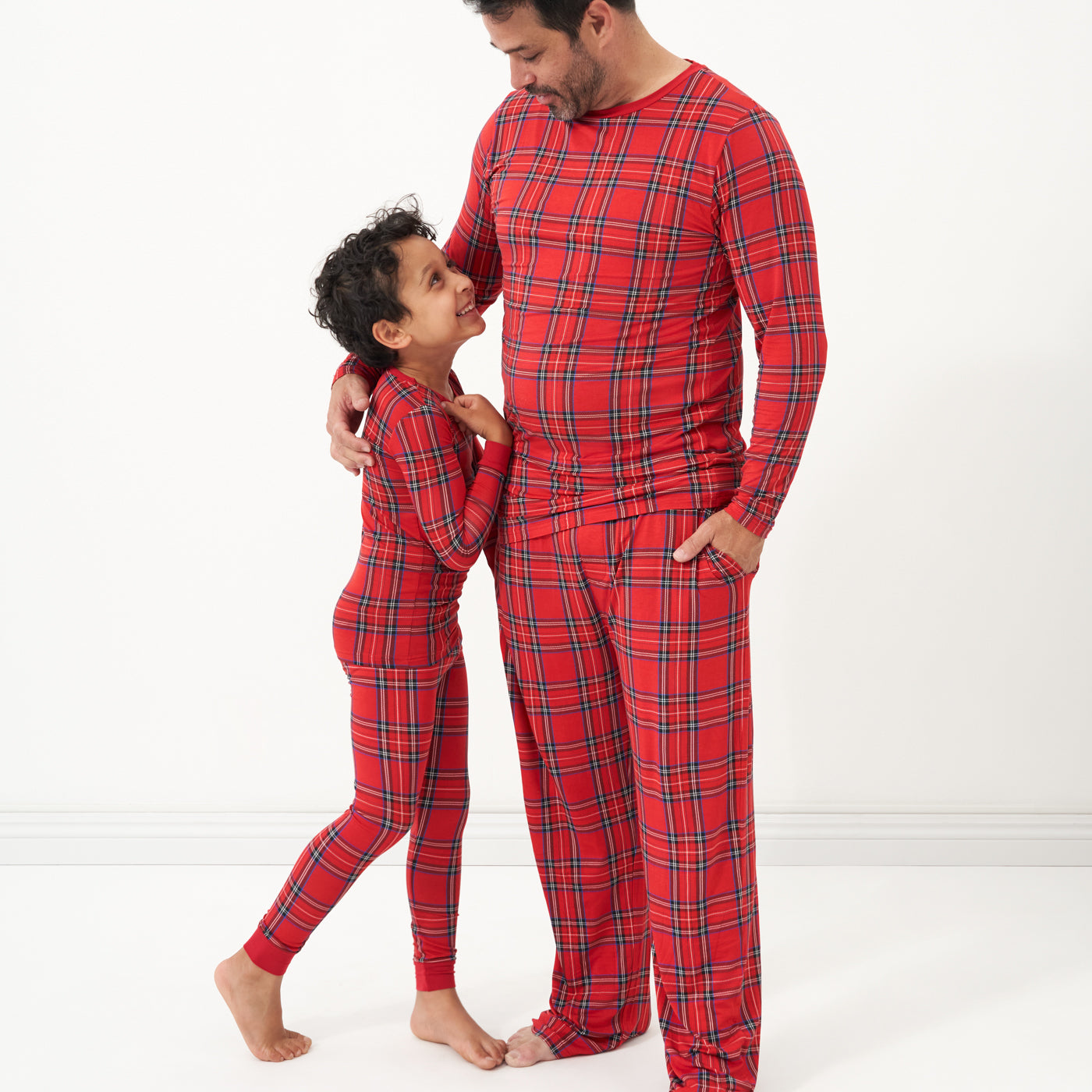 Father and child wearing matching Holiday Plaid pajamas
