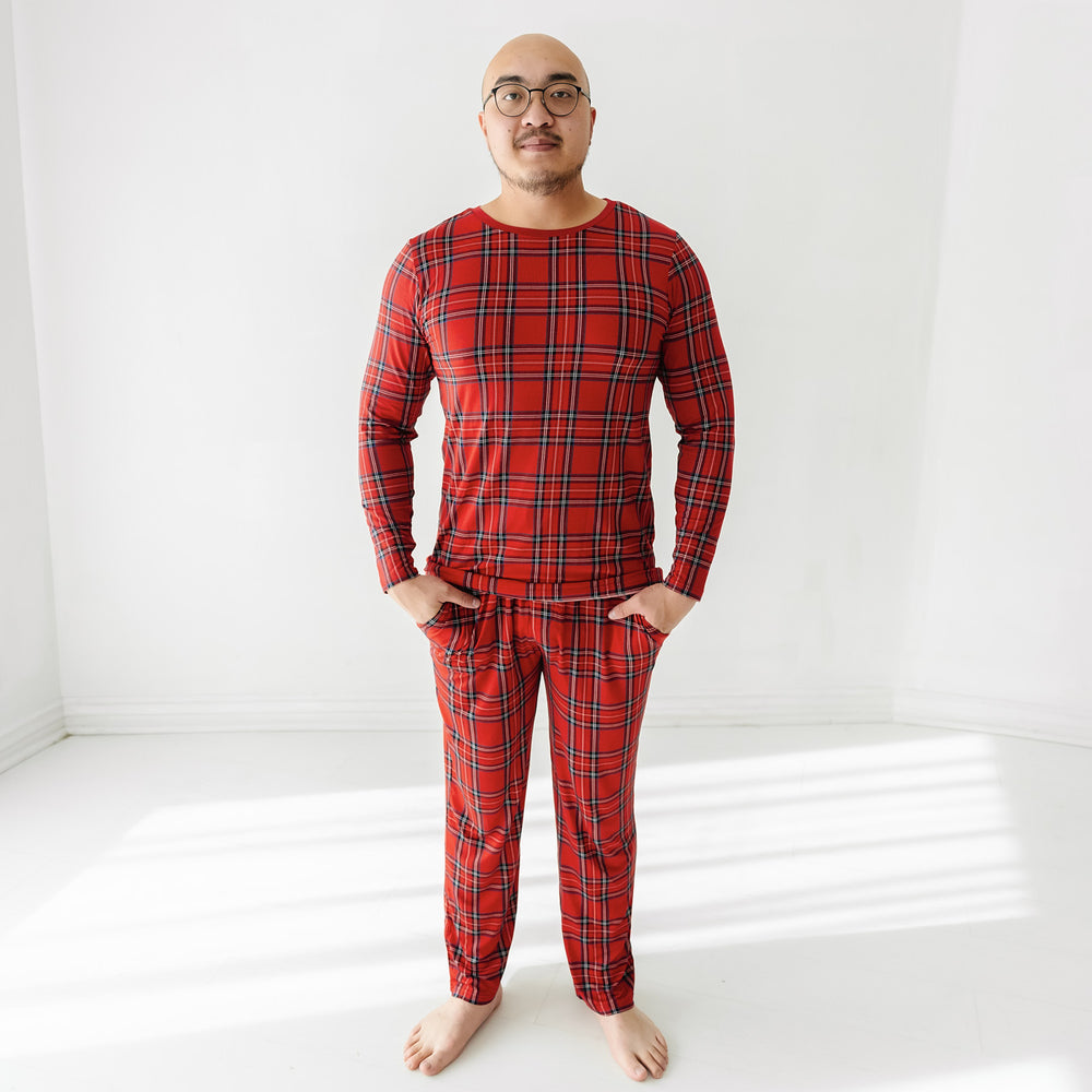 Man wearing men's Holiday Plaid pajama pants and matching pajama top