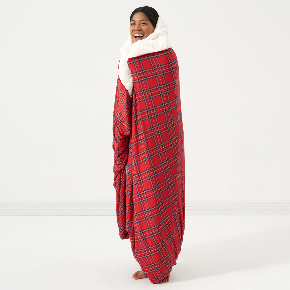 Woman wrapped up in a Holiday Plaid plush oversized cloud blanket