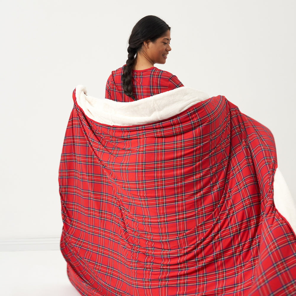 Back view of a woman wrapped up in a Holiday Plaid plush oversized cloud blanket