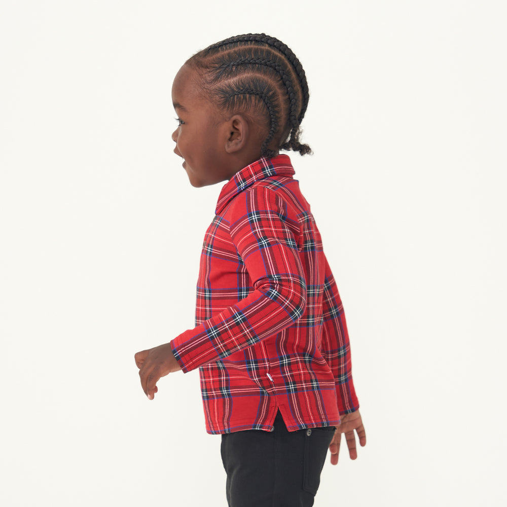 Side view image of a child wearing a Holiday Plaid polo shirt