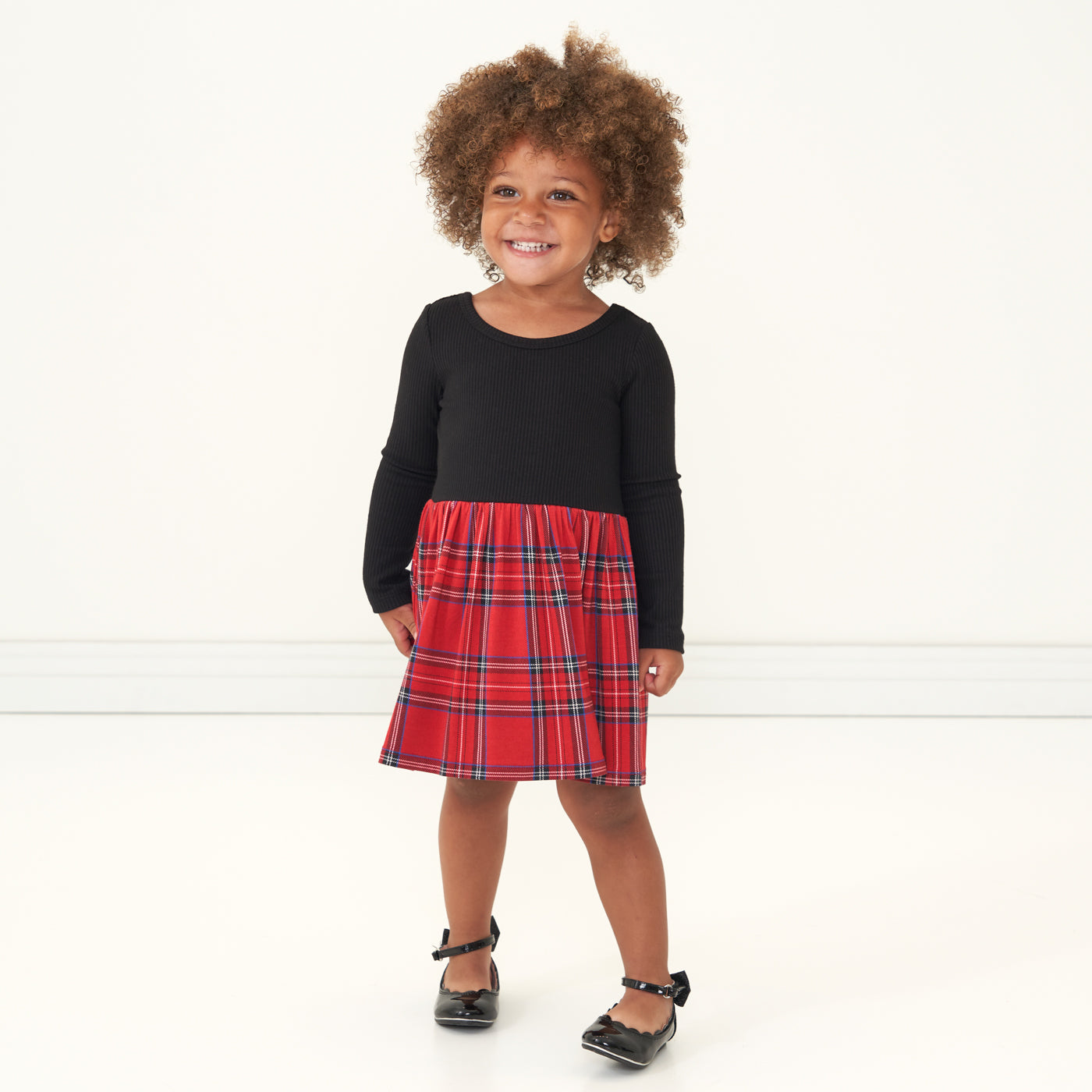 Child wearing a Holiday Plaid skater dress with bodysuit