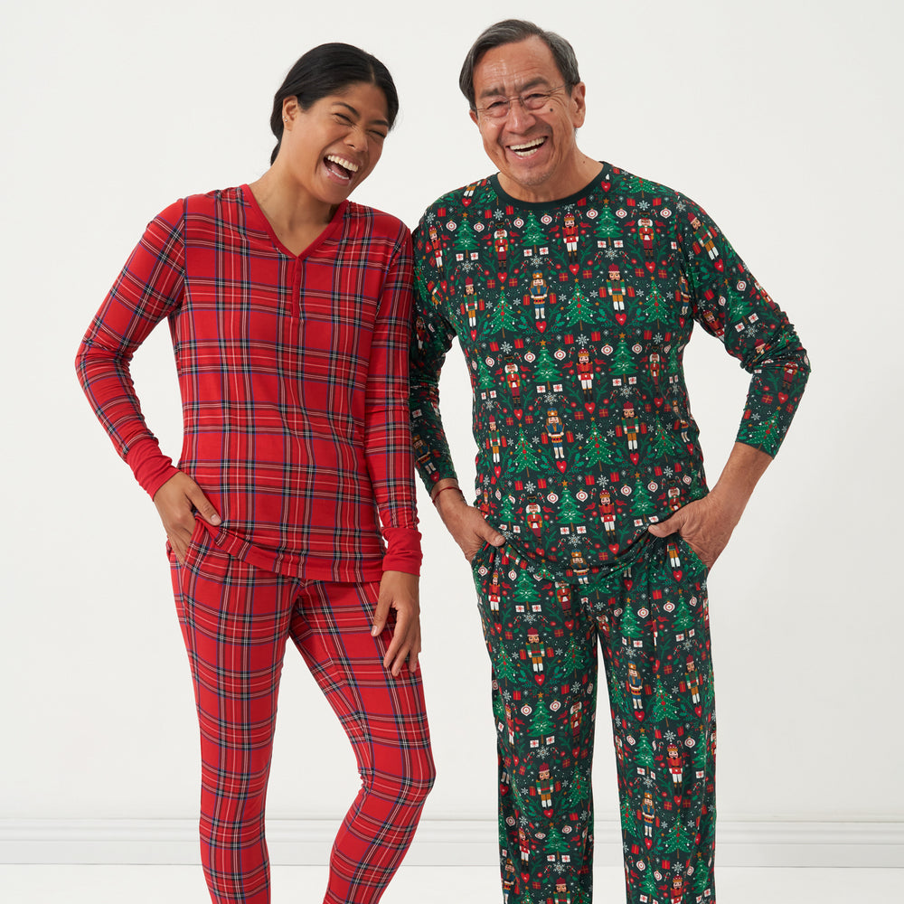 Woman and man wearing coordinating holiday pajamas