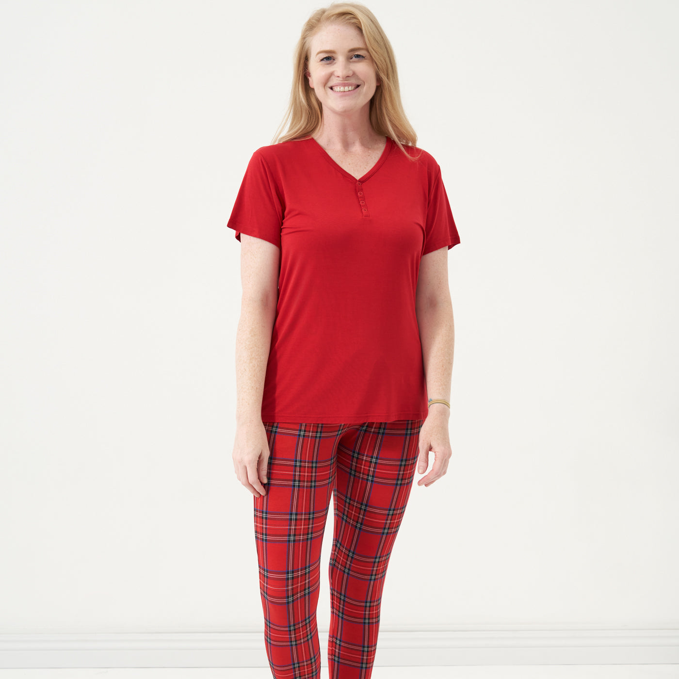 Woman wearing Holiday Plaid women's pajama pants and coordinating Holiday Red short sleeve pajama top