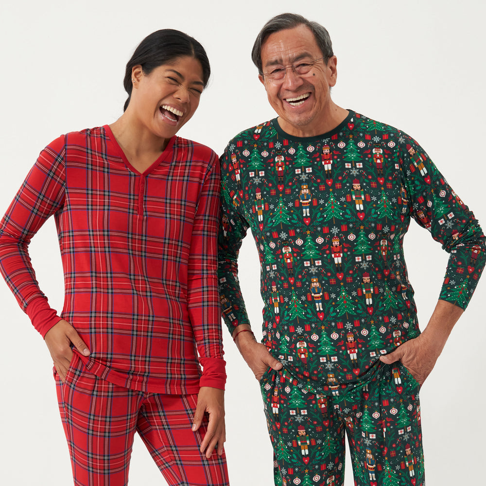 Man and woman wearing coordinating holiday pajamas