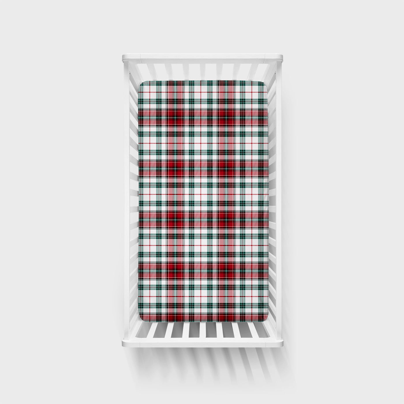 Overhead view of the Holly Plaid Fitted Crib Sheet