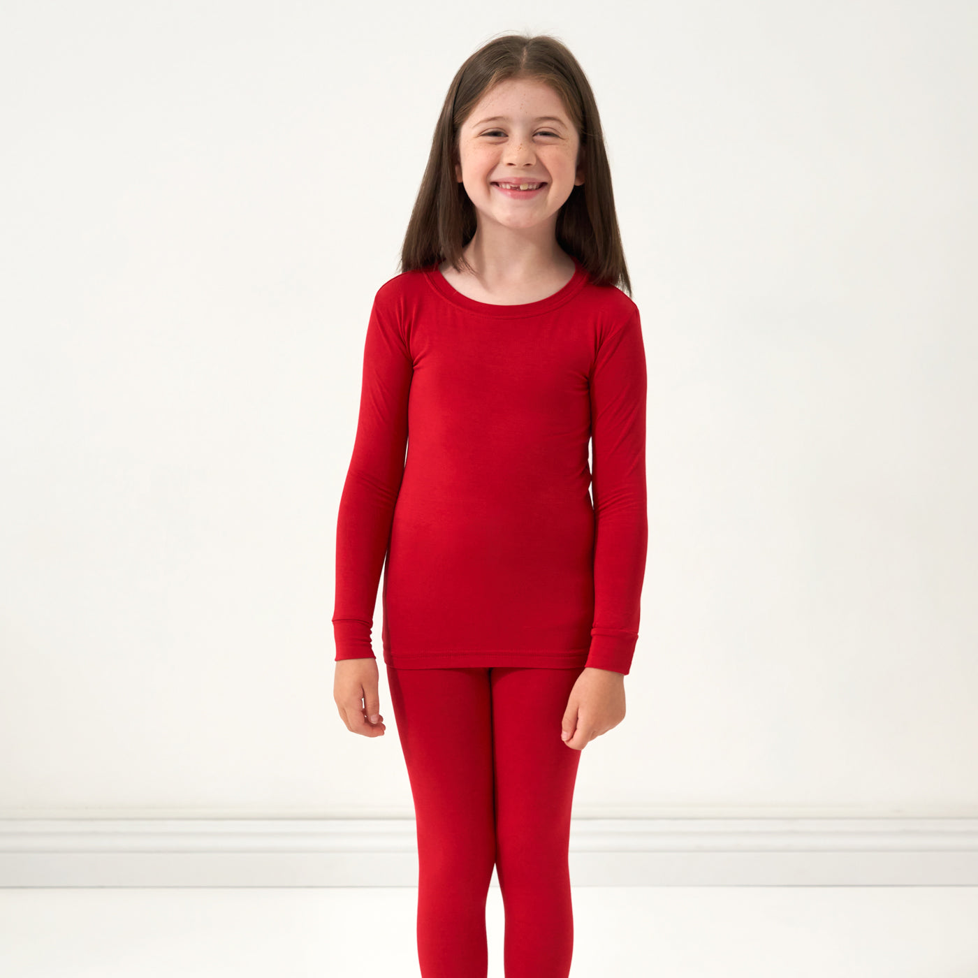 Alternate close up image of a child wearing a Holiday Red two-piece pajama set