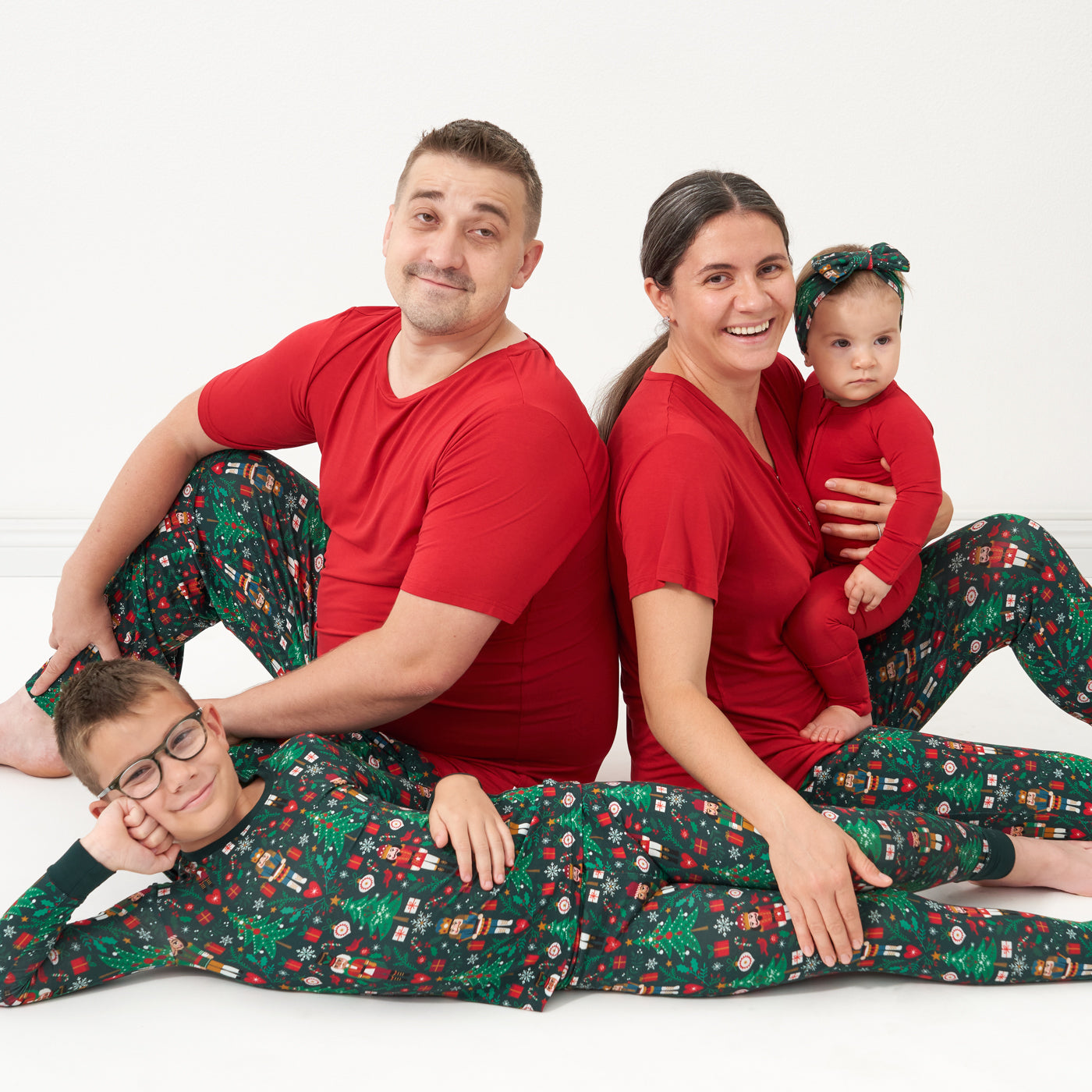Family wearing coordinating holiday pajamas by Little Sleepies