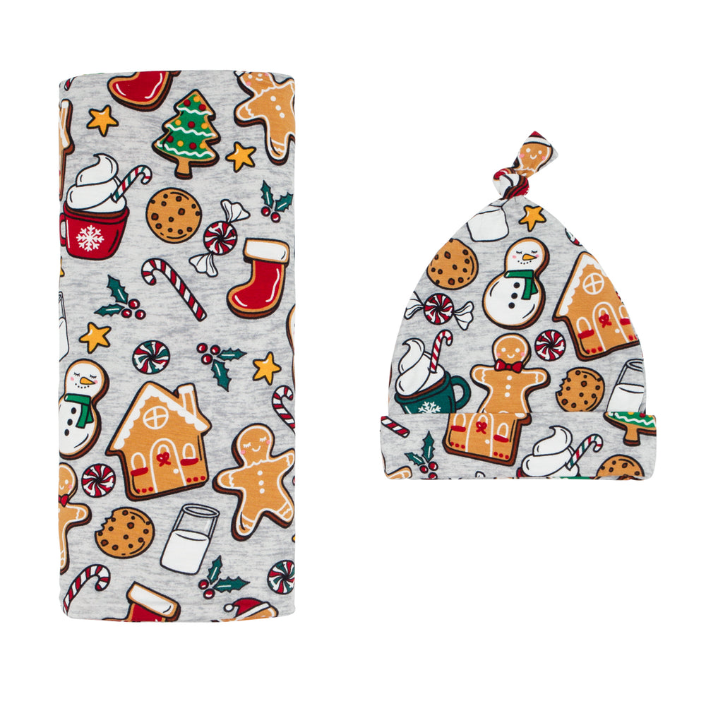 Flat lay image of a  Holiday Treats swaddle and hat set