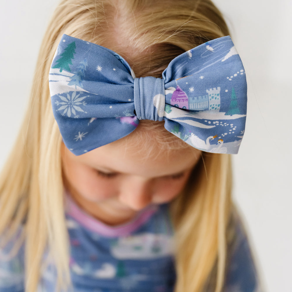 Close up image of a child wearing an Ice Princess luxe bow headband