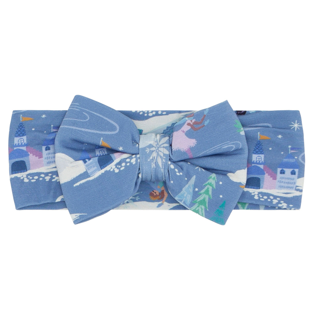 Flat lay image of an Ice Princess luxe bow headband in size newborn to age three