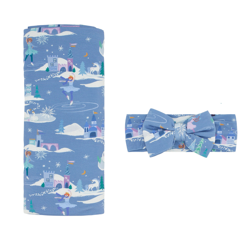Flat lay image of an Ice Princess printed swaddle and luxe bow headband set