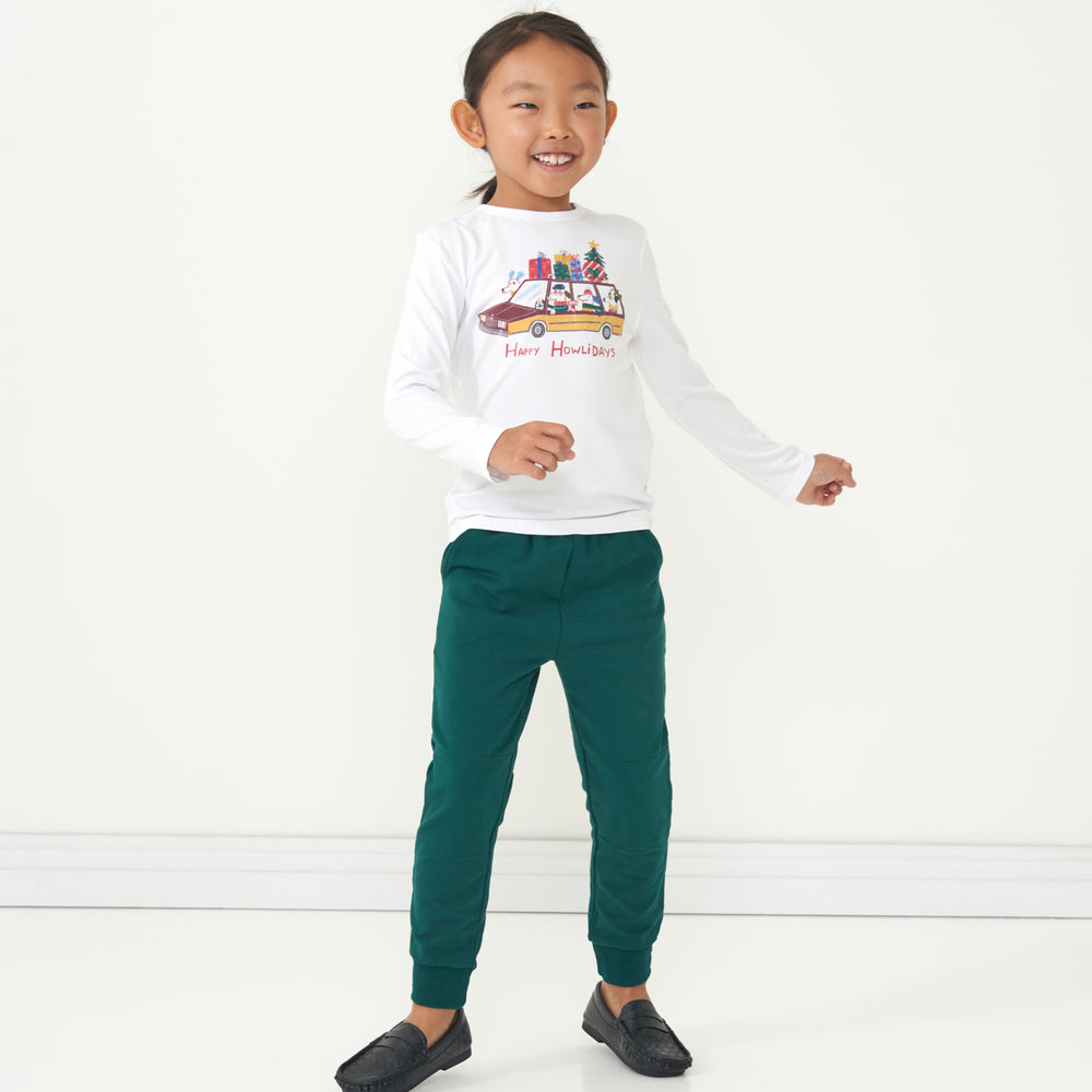 Child wearing Emerald Joggers paired with a Happy Howlidays graphic tee
