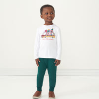 Alternate image of a child wearing Emerald Joggers paired with a Happy Howlidays graphic tee