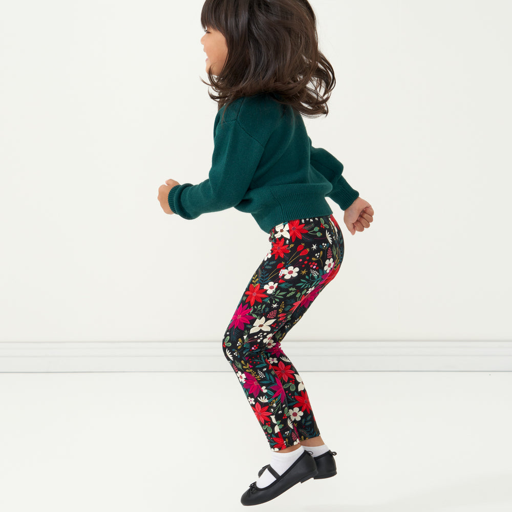 Child jumping wearing Berry Merry Leggings paired with an Emerald Knit Sweater