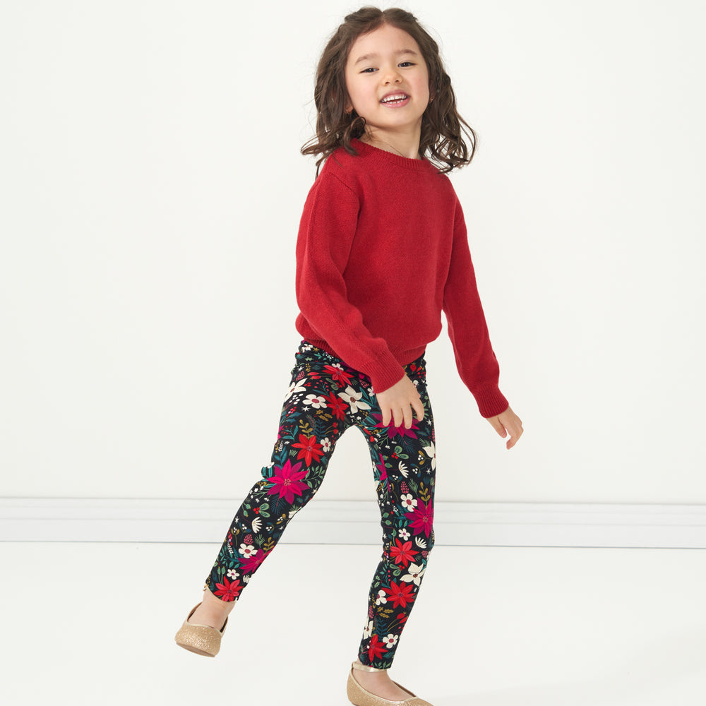 Child jumping wearing Berry Merry Leggings paired with a Holiday Red Knit Sweater