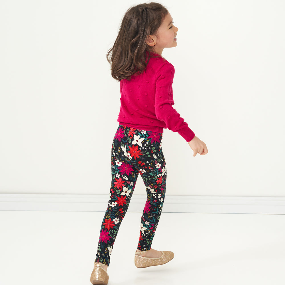 Child jumping wearing Berry Merry Leggings paired with an Mixed Berry Pom Pom Sweater