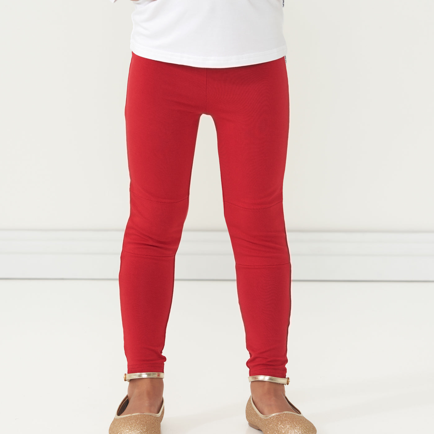 Close up image of a child wearing Holiday Red Leggings