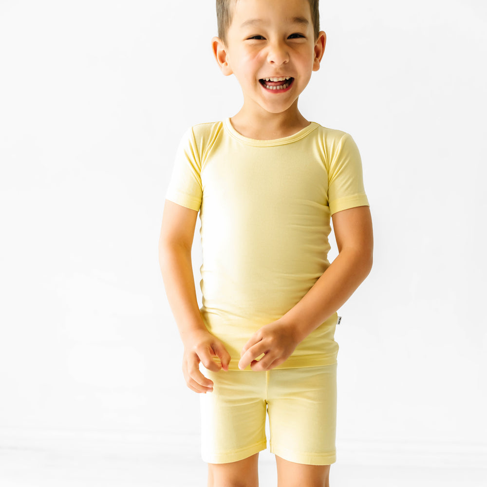 close up image of a child wearing a Lemon Twist two piece short sleeve and shorts pajama set